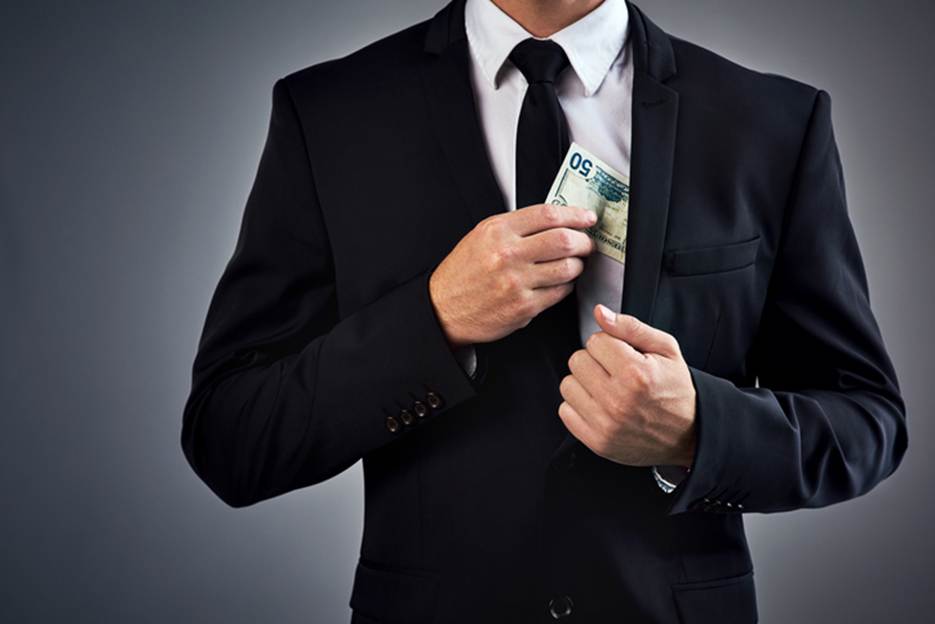 A person putting money in his pocket
AI-generated content may be incorrect.
